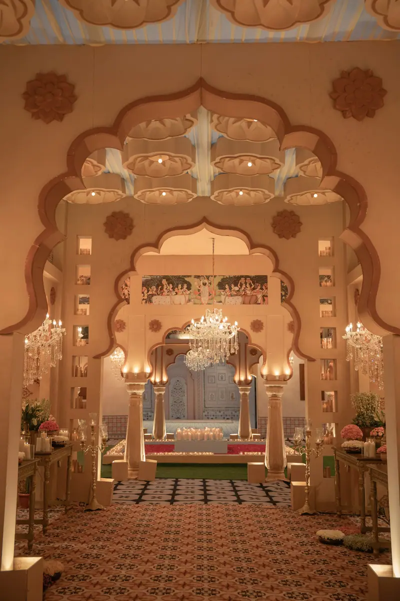 Carved sandstone arches with crystal chandeliers in the haveli's entrance gallery